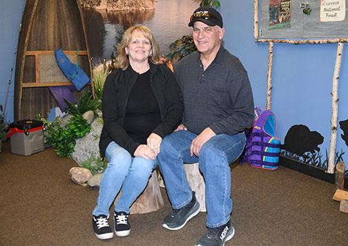 Dan and Linda Huenefeld pose for a final photo in the Boundary Waters escape room game, which featured puzzles all created personally by the owners.