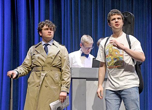Sam Elge, left, plays Owen Casey, a private investigator who is not amused by aspiring musician Nelson Henry, played by student actor Atticus Miller, right. At center is a ticket holder played by Derek Wilson.