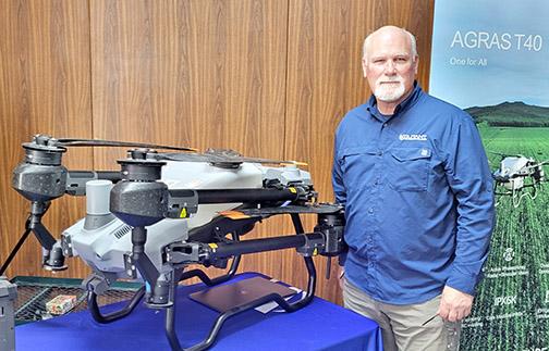 Kevin Knorr, CEO of Volitant Technologies of Nebraska City, stands beside the DJI Agras T-40 sprayer drone he brought to display at the first-ever Nebraska Sprayer Drone Conference Thursday at the the Leadership Center. Knorr led off the day-long conference with a talk on new innovations in drone technology for the farm.