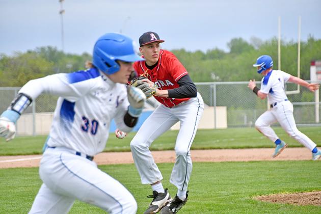 Aurora pitcher Booker Scheierman fields a bunt and sets up for a toss over to first base for the out. 
