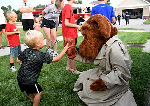McGruff gets a high five during National Night Out in the Lincoln Creek neighborhood.