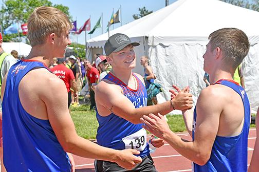 Eighth place finisher in the shot put, Wyatt Urkoski (middle) celebrates with relay runners Carter Urkoski (left) and Haden Helgoth after winning gold at the state track meet.