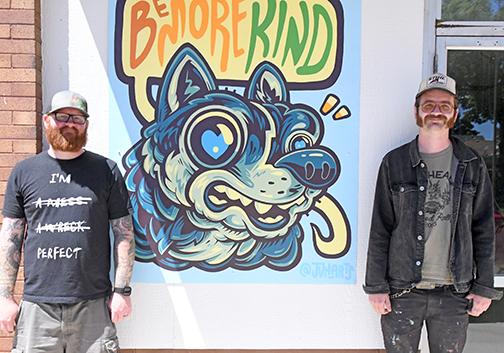A new mural for the Hamilton County Youth Center was bolted to the side of the building Friday, May 24. Pictured from left are Youth Center Executive Director Paul Johnson and mural artist John Van Horn.