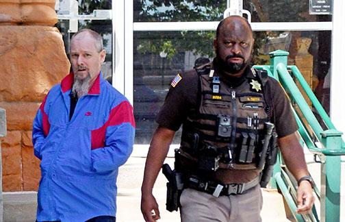 Murder defendant Jeffrey Adams leaves the Hamilton County Courthouse on Friday in the custody of Chief Deputy Aaron Smith