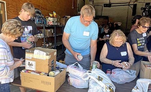 Sorting through cans of food donated during Can Care-a-Van, volunteers check to make sure the food isn’t expired and prepare to put them on shelves. From left are, Sally Roblee, Graham Christenson, John Christenson, Shirely Schacht and Diana Shaffer.
