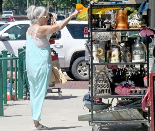 Business was brisk for Aurora’s revived sidewalk sales event on Friday. Shoppers of all ages checked out the bargains merchants had placed on the sidewalk for the day. 